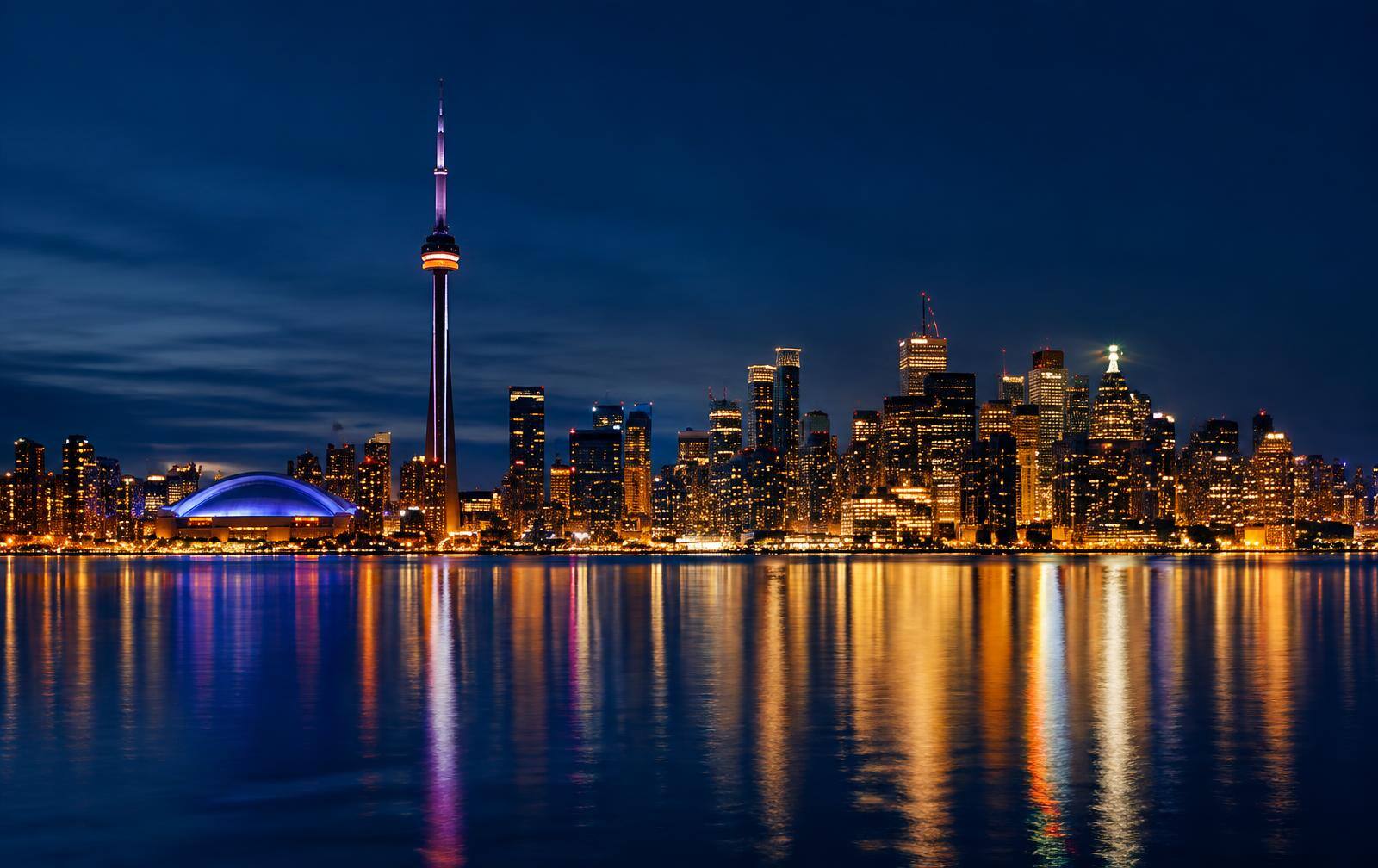 Toronto skyline at night reflecting on Lake Ontario